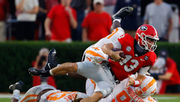 ATHENS, GEORGIA - OCTOBER 10: Stetson Bennett #13 of the Georgia Bulldogs dives for more yardage against Jeremy Banks #33, Darel Middleton #97, and Matthew Butler #94 of the Tennessee Volunteers during the second half at Sanford Stadium on October 10, 2020 in Athens, Georgia. (Photo by Kevin C. Cox/Getty Images)