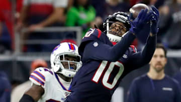 HOUSTON, TEXAS - JANUARY 04: Wide receiver DeAndre Hopkins #10 of the Houston Texans makes a catch over Tre'Davious White #27 of the Buffalo Bills during the AFC Wild Card Playoff game at NRG Stadium on January 04, 2020 in Houston, Texas. (Photo by Tim Warner/Getty Images)