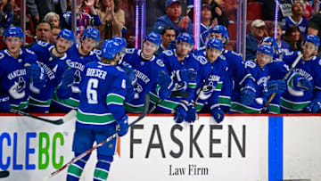 VANCOUVER, BC - MARCH 23: Brock Boeser #6 of the Vancouver Canucks is congratulated by teammates after scoring during their NHL game against the Calgary Flames at Rogers Arena March 23, 2019 in Vancouver, British Columbia, Canada. (Photo by Jeff Vinnick/NHLI via Getty Images)