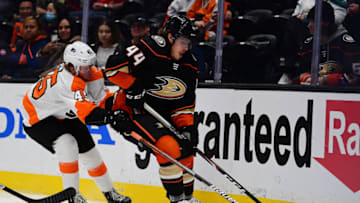 Jan 4, 2022; Anaheim, California, USA; Anaheim Ducks left wing Max Comtois (44) moves the puck against Philadelphia Flyers defenseman Cam York (45) during the second period at Honda Center. Mandatory Credit: Gary A. Vasquez-USA TODAY Sports
