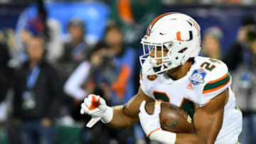 CHARLOTTE, NC - DECEMBER 02: Miami Hurricanes running back Travis Homer (24) runs the ball during the ACC Championship game between the Miami Hurricanes and the Clemson Tigers on December 02, 2017 at bank of America Stadium in Charlotte, NC.(Photo by Dannie Walls/Icon Sportswire via Getty Images)