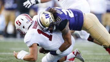 Sep 30, 2016; Seattle, WA, USA; Washington Huskies linebacker Psalm Wooching (28) sacks Stanford Cardinal quarterback Ryan Burns (17) during the first quarter at Husky Stadium. Mandatory Credit: Jennifer Buchanan-USA TODAY Sports