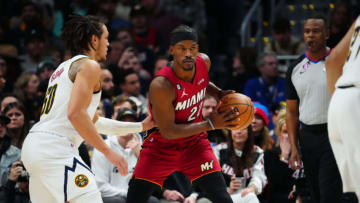 Dec 30, 2022; Denver, Colorado, USA; Miami Heat forward Jimmy Butler (22) controls the ball away from Denver Nuggets forward Aaron Gordon (50) in the second quarter at Ball Arena. Mandatory Credit: Ron Chenoy-USA TODAY Sports