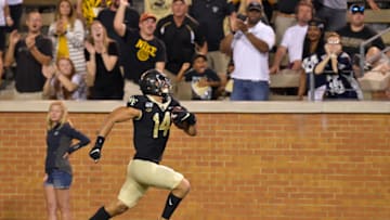 WINSTON SALEM, NORTH CAROLINA - AUGUST 30: Sage Surratt #14 of the Wake Forest Demon Deacons against the Utah State Aggies during their game at BB&T Field on August 30, 2019 in Winston Salem, North Carolina. Wake Forest won 38-35. (Photo by Grant Halverson/Getty Images)