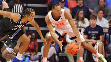 Nov 6, 2023; Champaign, Illinois, USA; Illinois Fighting Illini forward Ty Rodgers (20) grabs a loose ball in front of Eastern Illinois Panthers guard Nakyel Shelton (3) during the second half at State Farm Center. Mandatory Credit: Ron Johnson-USA TODAY Sports