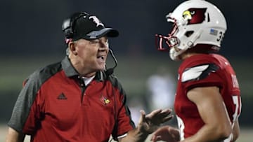 Sep 1, 2016; Louisville, KY, USA; Louisville Cardinals head coach Bobby Petrino reacts with one on his players after a touchdown against the Charlotte 49ers during the second half at Papa John