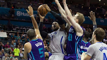 Apr 8, 2016; Charlotte, NC, USA; Brooklyn Nets forward Chris McCullough (1) shoots the ball between Charlotte Hornets forward Nicolas Batum (5) and center Cody Zeller (40) in the second half at Time Warner Cable Arena. The Hornets defeated the Nets 113-99. Mandatory Credit: Jeremy Brevard-USA TODAY Sports