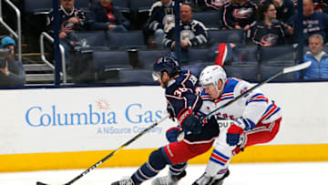 Dec 5, 2019; Columbus, OH, USA; Columbus Blue Jackets center Boone Jenner (38) skates with the puck past New York Rangers defenseman Libor Hajek (25) during the first period at Nationwide Arena. Mandatory Credit: Russell LaBounty-USA TODAY Sports