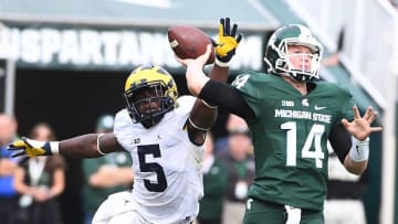 Oct 29, 2016; East Lansing, MI, USA; Michigan State Spartans quarterback Brian Lewerke (14) attempts a pass as Michigan Wolverines linebacker Jabrill Peppers (5) defends during the second half at Spartan Stadium. Mandatory Credit: Brad Mills-USA TODAY Sports