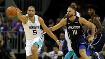 CHARLOTTE, NC - DECEMBER 04: Nicolas Batum #5 of the Charlotte Hornets goes after a loose ball against Evan Fournier #10 of the Orlando Magic during their game at Spectrum Center on December 4, 2017 in Charlotte, North Carolina. NOTE TO USER: User expressly acknowledges and agrees that, by downloading and or using this photograph, User is consenting to the terms and conditions of the Getty Images License Agreement. (Photo by Streeter Lecka/Getty Images)