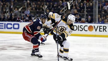 Oct 26, 2016; New York, NY, USA; Boston Bruins defenseman John-Michael Liles (26) battles for the puck with New York Rangers right wing Michael Grabner (40) during the second period at Madison Square Garden. Mandatory Credit: Adam Hunger-USA TODAY Sports