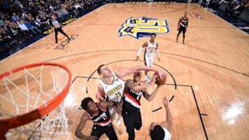 DENVER, CO - JANUARY 22: Nikola Jokic #15 of the Denver Nuggets blocks the shot by Shabazz Napier #6 of the Portland Trail Blazers during the game between the two teams on January 22, 2018 at the Pepsi Center in Denver, Colorado. NOTE TO USER: User expressly acknowledges and agrees that, by downloading and/or using this Photograph, user is consenting to the terms and conditions of the Getty Images License Agreement. Mandatory Copyright Notice: Copyright 2018 NBAE (Photo by Garrett Ellwood/NBAE via Getty Images)