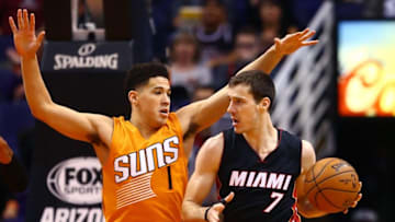 Jan 8, 2016; Phoenix, AZ, USA; Miami Heat guard Goran Dragic (right) controls the ball against Phoenix Suns guard Devin Booker in the first quarter at Talking Stick Resort Arena. Mandatory Credit: Mark J. Rebilas-USA TODAY Sports