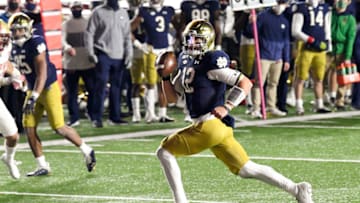 Nov 14, 2020; Chestnut Hill, Massachusetts, USA; Notre Dame Fighting Irish quarterback Ian Book (12) runs for a touchdown against the Boston College Eagles during the second half at Alumni Stadium. Mandatory Credit: Brian Fluharty-USA TODAY Sports