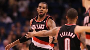February 10, 2013; Orlando FL, USA; Portland Trail Blazers power forward LaMarcus Aldridge (12) high fives point guard Damian Lillard (0) after he slam dunkes against the Orlando Magic during the second half at Amway Center. Orlando Magic defeated the Portland Trail Blazers 110-104. Mandatory Credit: Kim Klement-USA TODAY Sports