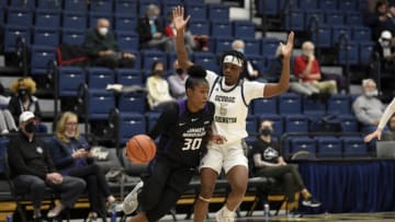WASHINGTON, DC - DECEMBER 02: Kiki Jefferson #30 of the James Madison Dukes handles the ball against Tyasia Moore #5 of the George Washington Colonials at Charles E. Smith Athletic Center on December 02, 2021 in Washington, DC. (Photo by G Fiume/Getty Images)
