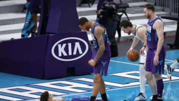 CHARLOTTE, NORTH CAROLINA - JANUARY 30: LaMelo Ball #2 of the Charlotte Hornets reacts with teammate P.J. Washington #25 following a basket and a foul during the fourth quarter of their game against the Milwaukee Bucks at Spectrum Center on January 30, 2021 in Charlotte, North Carolina. NOTE TO USER: User expressly acknowledges and agrees that, by downloading and or using this photograph, User is consenting to the terms and conditions of the Getty Images License Agreement. (Photo by Jared C. Tilton/Getty Images)