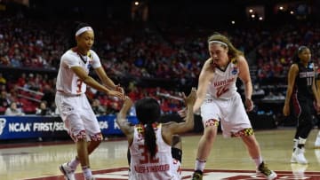 Mar 21, 2015; College Park, MD, USA; Maryland Terrapins Brene Moseley (3) and Tierney Pfirman (22) help Shatori Walker-Kimbrough (32) off of the floor against the New Mexico State Aggies in the first round of the women
