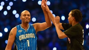 Feb 14, 2015; New York, NY, USA; Team Westbrook legend Penny Hardaway (1) and Team Westbrook forward Tamika Catchings of the Indiana Fever (24, right) high-five during the 2015 NBA All Star Shooting Stars competition at Barclays Center. Mandatory Credit: Bob Donnan-USA TODAY Sports