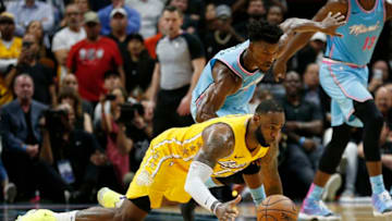 LeBron James #23 of the Los Angeles Lakers battles for a loose ball with Jimmy Butler #22 of the Miami Heat (Photo by Michael Reaves/Getty Images)