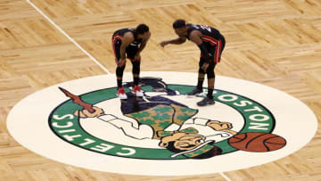 Kyle Lowry #7 and Jimmy Butler #22 of the Miami Heat talk against the Boston Celtics(Photo by Winslow Townson/Getty Images)