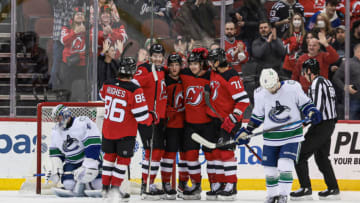 Feb 28, 2022; Newark, New Jersey, USA; New Jersey Devils center Yegor Sharangovich (17) celebrates his goal with teammates past Vancouver Canucks goaltender Jaroslav Halak (41) during the first period at Prudential Center. Mandatory Credit: Vincent Carchietta-USA TODAY Sports