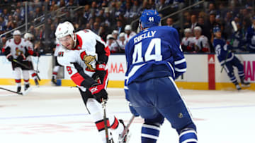 TORONTO, ON - OCTOBER 02: Morgan Rielly #44 of the Toronto Maple Leafs defends as Bobby Ryan #9 of the Ottawa Senators shoots the puck during an NHL game at Scotiabank Arena on October 2, 2019 in Toronto, Canada. (Photo by Vaughn Ridley/Getty Images)