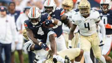 Auburn football running back Tank Bigsby (4) steps over a defender as he runs the ball at Jordan-Hare Stadium in Auburn, Ala., on Saturday, Sept. 4, 2021. Auburn Tigers leads Akron Zips 37-0.