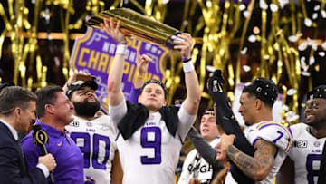NEW ORLEANS, LA - JANUARY 13: Joe Burrow #9 of the LSU Tigers holds up the trophy after defeating the Clemson Tigers during the College Football Playoff National Championship held at the Mercedes-Benz Superdome on January 13, 2020 in New Orleans, Louisiana. (Photo by Jamie Schwaberow/Getty Images)