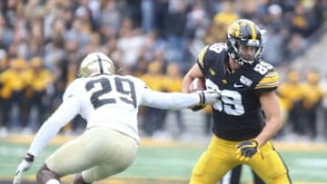 IOWA CITY, IOWA- OCTOBER 19: Wide receiver Nico Ragaini #89 of the Iowa Hawkeyes breaks a tackle during the second half by cornerback Simeon Smiley #29 of the Purdue Boilermakers on October 19, 2019 at Kinnick Stadium in Iowa City, Iowa. (Photo by Matthew Holst/Getty Images)