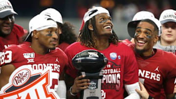 ARLINGTON, TX - DECEMBER 07: CeeDee Lamb #2 of the Oklahoma Sooners (with trophy) and teammate Jalen Hurts #1 (right) celebrate after defeating the Baylor Bears 30-23 in the Big 12 Football Championship at AT&T Stadium on December 7, 2019 in Arlington, Texas. (Photo by Ron Jenkins/Getty Images)