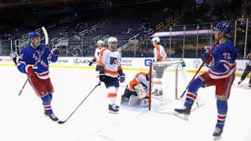 NEW YORK, NEW YORK - APRIL 23: Filip Chytil #72 of the New York Rangers (R) celebrates his third period goal against Alex Lyon #34 of the Philadelphia Flyers and is joined by Kaapo Kakko #24 (L) at Madison Square Garden on April 23, 2021 in New York City. The Rangers defeated the Flyers 4-1. (Photo by Bruce Bennett/Getty Images)