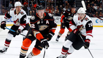 ANAHEIM, CA - OCTOBER 10: Josh Manson #42 of the Anaheim Ducks skates with the puck against Dylan Strome #20 and Richard Panik #14 of the Arizona Coyotes during the game on October 10, 2018 at Honda Center in Anaheim, California. (Photo by Debora Robinson/NHLI via Getty Images)