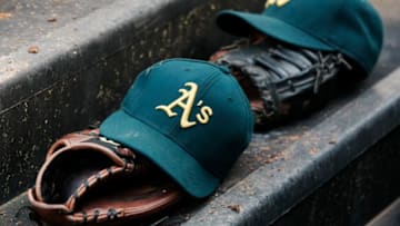 ARLINGTON, TX - MAY 21: Oakland Athletics hats and gloves during a baseball game against the Texas Rangers at Rangers Ballpark on May 21, 2013 in Arlington, Texas. Oakland Athletics won 1-0. (Photo by Brandon Wade/Getty Images)