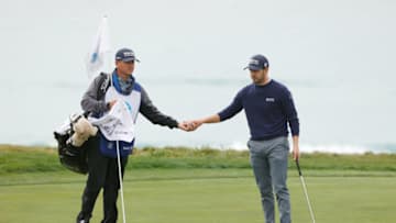PEBBLE BEACH, CALIFORNIA - FEBRUARY 11: Patrick Cantlay of the United States talks with his caddie on the tenth green during the first round of the AT&T Pebble Beach Pro-Am at Pebble Beach Golf Links on February 11, 2021 in Pebble Beach, California. (Photo by Ezra Shaw/Getty Images)