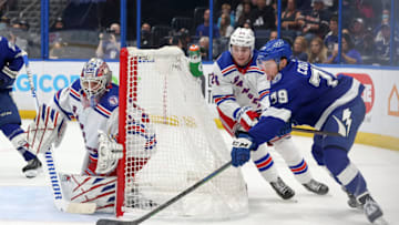 TAMPA, FL - DECEMBER 31: Ross Colton #79 of the Tampa Bay Lightning tries to wrap around a shot against Igor Shesterkin #31 of the New York Rangers as Kaapo Kakko #24 defends during the second period at the Amalie Arena on December 31, 2021 in Tampa, Florida. (Photo by Mike Carlson/Getty Images)