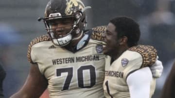 Nov 27, 2015; Toledo, OH, USA; Western Michigan Broncos offensive lineman Willie Beavers (70) celebrates with safety Rontavious Atkins (1) after the game against the Toledo Rockets at Glass Bowl. Broncos win 35-30. Mandatory Credit: Raj Mehta-USA TODAY Sports
