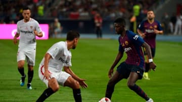 Sevilla's Spanish midfielder Jesus Navas (L) vies with Barcelona's French forward Ousmane Dembele during the Spanish Super Cup final between Sevilla and FC Barcelona at Ibn Batouta stadium in the Moroccan city of Tangiers on August 12, 2018. (Photo by FADEL SENNA / AFP) (Photo credit should read FADEL SENNA/AFP/Getty Images)