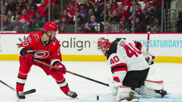 May 3, 2023; Raleigh, North Carolina, USA; Carolina Hurricanes center Sebastian Aho (20) scoring attempt is stopped by New Jersey Devils goaltender Akira Schmid (40) during the first period in game one of the second round of the 2023 Stanley Cup Playoffs at PNC Arena. Mandatory Credit: James Guillory-USA TODAY Sports