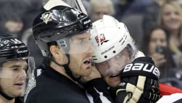 Mar 11, 2014; Pittsburgh, PA, USA; Pittsburgh Penguins defenseman Brooks Orpik (44) applies a head lock on Washington Capitals center Jay Beagle (83) during a scuffle in the third period at the CONSOL Energy Center. The Penguins won 2-0. Mandatory Credit: Charles LeClaire-USA TODAY Sports