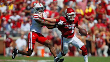 NORMAN, OK - SEPTEMBER 18: Quarterback Spencer Rattler #7 of the Oklahoma Sooners gets his hands in the facemask of cornerback Quinton Newsome #6 of the Nebraska Cornhuskers for a personal foul in the second quarter at Gaylord Family Oklahoma Memorial Stadium on September 18, 2021 in Norman, Oklahoma. (Photo by Brian Bahr/Getty Images)