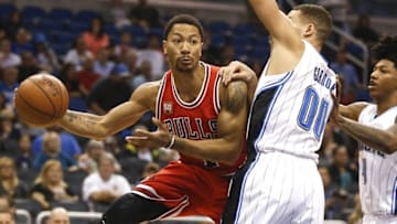 Mar 26, 2016; Orlando, FL, USA; Chicago Bulls guard Derrick Rose (1) passes around Orlando Magic forward Aaron Gordon (00) during the first quarter of a basketball game at Amway Center. Mandatory Credit: Reinhold Matay-USA TODAY Sports