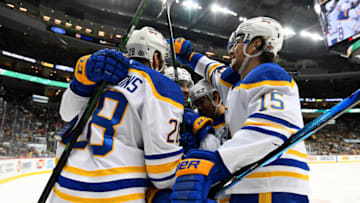 PITTSBURGH, PENNSYLVANIA - DECEMBER 17: Zemgus Girgensons #28 of the Buffalo Sabres celebrates his goal with teammates during the second period of a game against the Pittsburgh Penguins at PPG PAINTS Arena on December 17, 2021 in Pittsburgh, Pennsylvania. (Photo by Emilee Chinn/Getty Images)