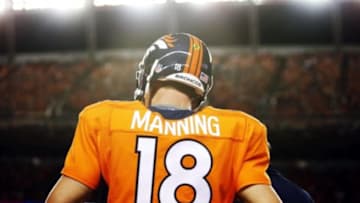 Sep 7, 2014; Denver, CO, USA; Denver Broncos quarterback Peyton Manning (18) on the sidelines during the second half against the Indianapolis Colts at Sports Authority Field at Mile High. The Broncos won 31-24. Mandatory Credit: Chris Humphreys-USA TODAY Sports