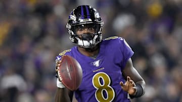 LOS ANGELES, CALIFORNIA - NOVEMBER 25: Quarterback Lamar Jackson #8 of the Baltimore Ravens looks to deliver a pass over the defense of the Los Angeles Rams at Los Angeles Memorial Coliseum on November 25, 2019 in Los Angeles, California. (Photo by Kevork Djansezian/Getty Images)