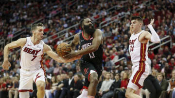 James Harden #13 of the Houston Rockets drives to the basket defended by Goran Dragic #7 of the Miami Heat and Tyler Herro #14(Photo by Tim Warner/Getty Images)