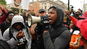 LONDON, ENGLAND - JUNE 03: Actor John Boyega speaks to the crowd during a Black Lives Matter protest in Hyde Park on June 3, 2020 in London, United Kingdom. The death of an African-American man, George Floyd, while in the custody of Minneapolis police has sparked protests across the United States, as well as demonstrations of solidarity in many countries around the world. (Photo by Justin Setterfield/Getty Images)