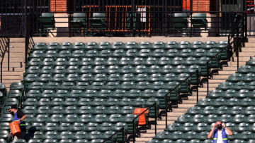 BALTIMORE, MARYLAND - JULY 29: Members of the Major League Baseball Authentication Program collect baseballs in the outfield before the start of the Baltimore Orioles and New York Yankees game at Oriole Park at Camden Yards on July 29, 2020 in Baltimore, Maryland. (Photo by Rob Carr/Getty Images)