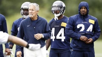 Jun 17, 2014; Renton, WA, USA; Seattle Seahawks head coach Pete Carroll and running back Marshawn Lynch (24, right) watch a scrimmage play minicamp at the Virginia Mason Athletic Center. Mandatory Credit: Joe Nicholson-USA TODAY Sports