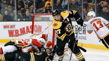BOSTON, MA - FEBRUARY 13: Boston Bruins center Patrice Bergeron (37) tries to latch onto the puck with a pile in the crease during a game between the Boston Bruins and the Calgary Flames on February 13, 2018, at TD Garden in Boston, Massachusetts. The Bruins defeated the Flames 5-2. (Photo by Fred Kfoury III/Icon Sportswire via Getty Images)